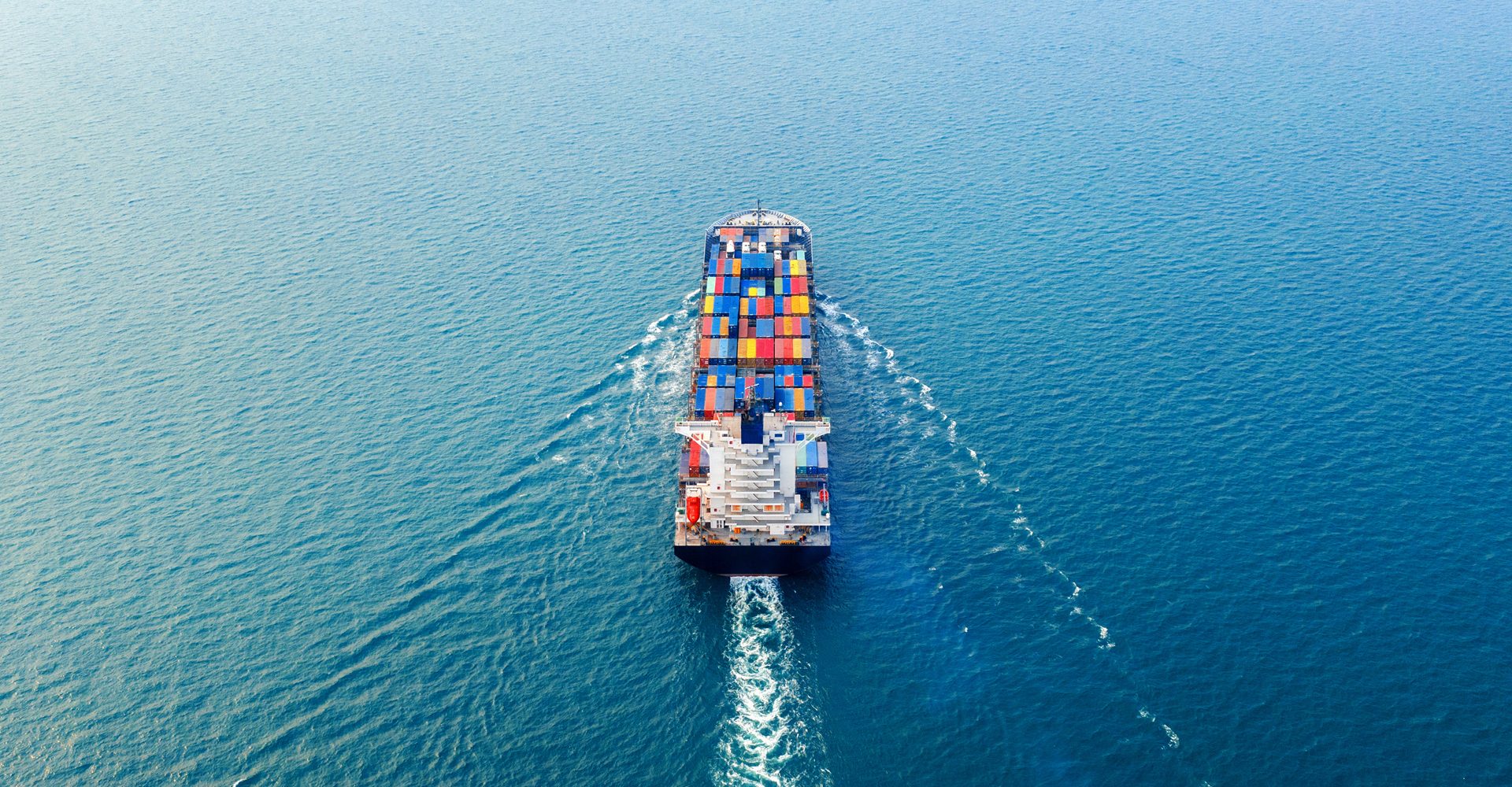 Aerial view of container cargo ship in sea.